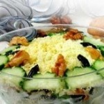 Russian Tenderness salad with prunes, chicken and cucumbers