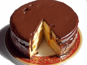 Russian charodeika sponge layers cake with anglaise cream and chocolate coating
